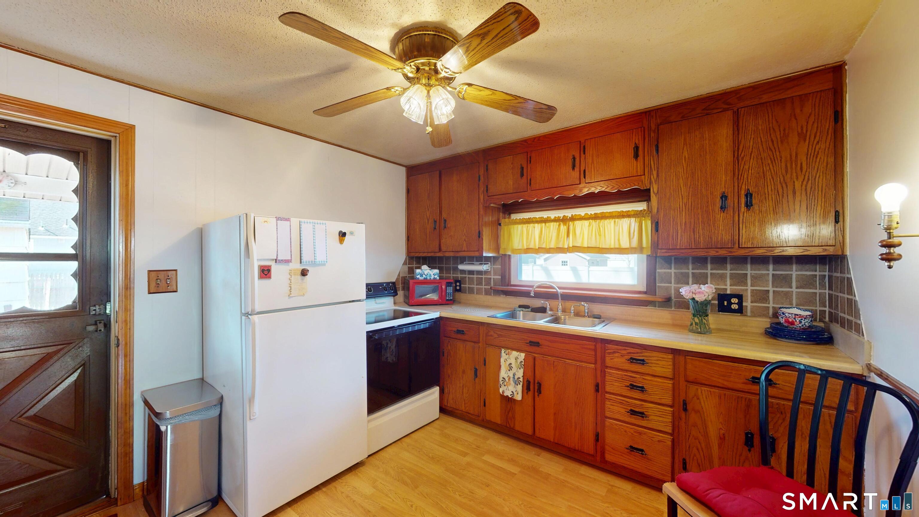 137 Brook Street Bristol, CT 06010 - Photo 23 of 37 a kitchen with sink cabinets and window
