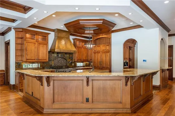 a kitchen with a stove a sink and a refrigerator