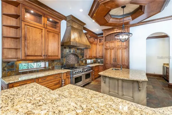 a kitchen with stainless steel appliances granite countertop a stove and a sink