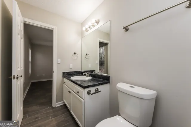 a bathroom with a granite countertop sink toilet and shower
