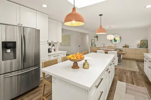 a kitchen with stainless steel appliances a stove a sink and a refrigerator