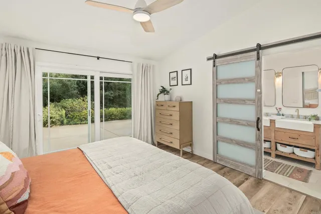a bathroom with double vanity sinks a mirror and a shower