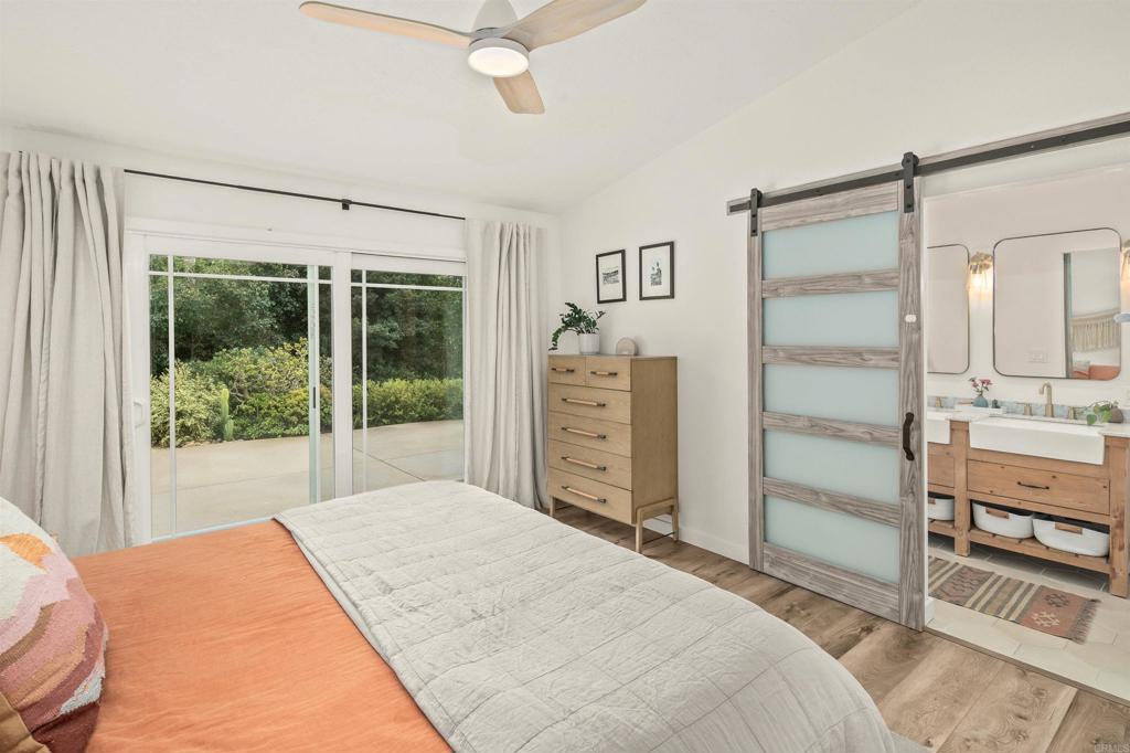 1427 Avocado Road Oceanside, CA 92054 - Photo 26 of 60 a bedroom with a large bed and a window