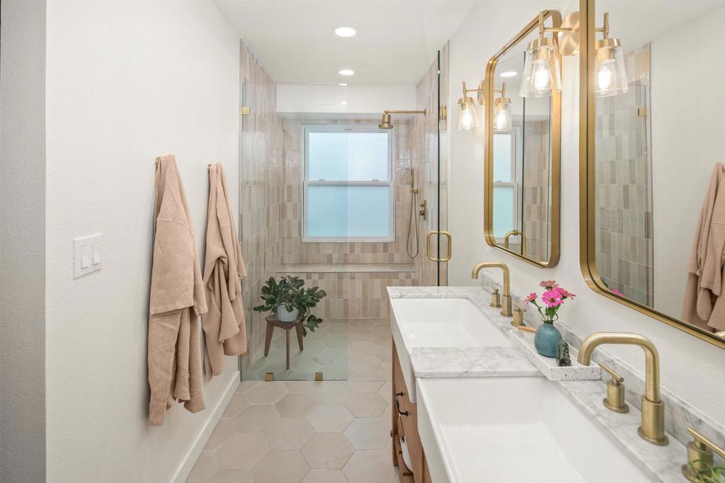 1427 Avocado Road Oceanside, CA 92054 - Photo 28 of 60 a bathroom with a tub sink and a mirror