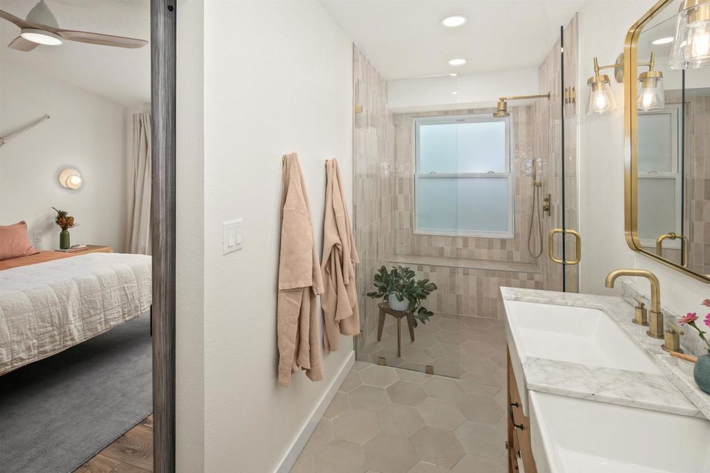 1427 Avocado Road Oceanside, CA 92054 - Photo 29 of 60 a bathroom with a tub sink and mirror