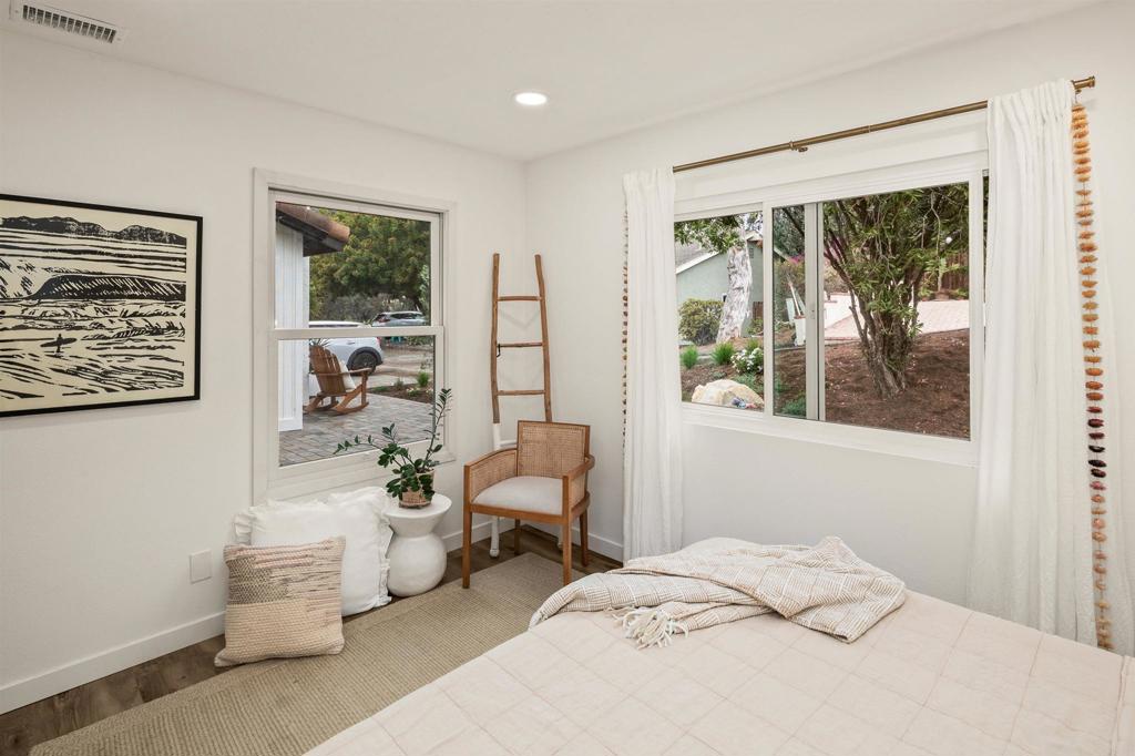 1427 Avocado Road Oceanside, CA 92054 - Photo 31 of 60 a bedroom with a bed and wooden floor