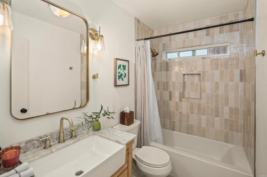 1427 Avocado Road Oceanside, CA 92054 - Photo 33 of 60 a bathroom with a sink and a mirror
