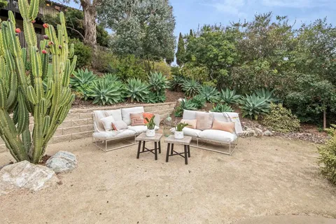a view of a house with backyard and porch