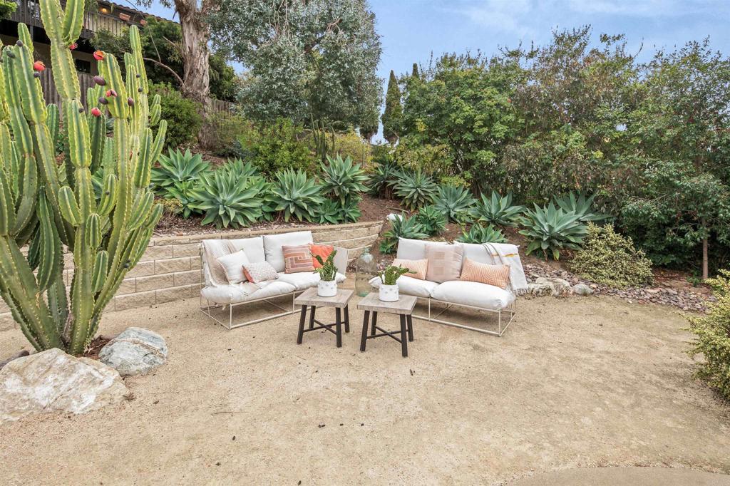 1427 Avocado Road Oceanside, CA 92054 - Photo 37 of 60 a backyard of a house with table and chairs
