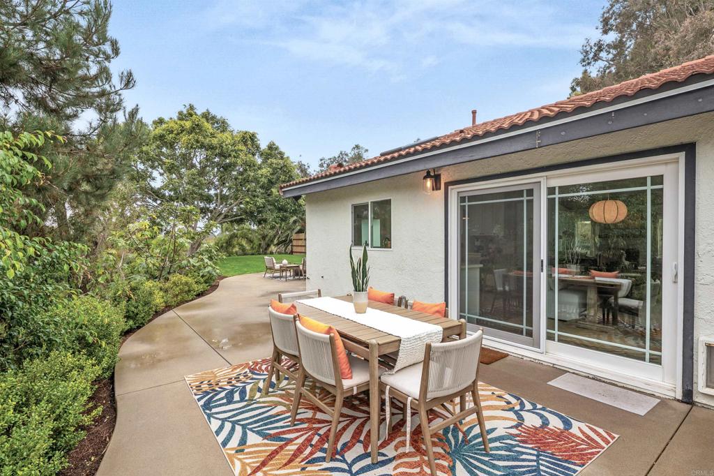 1427 Avocado Road Oceanside, CA 92054 - Photo 39 of 60 a backyard of a house with a table and chairs