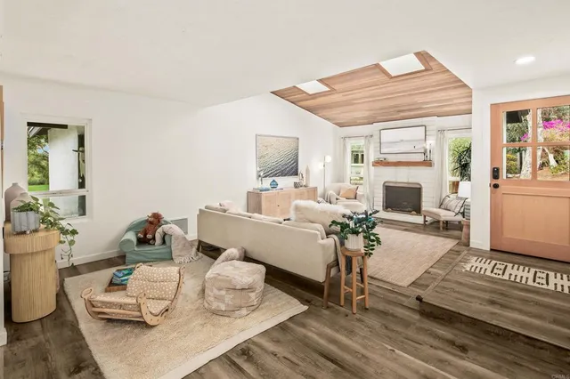 a living room with furniture a fireplace and a table