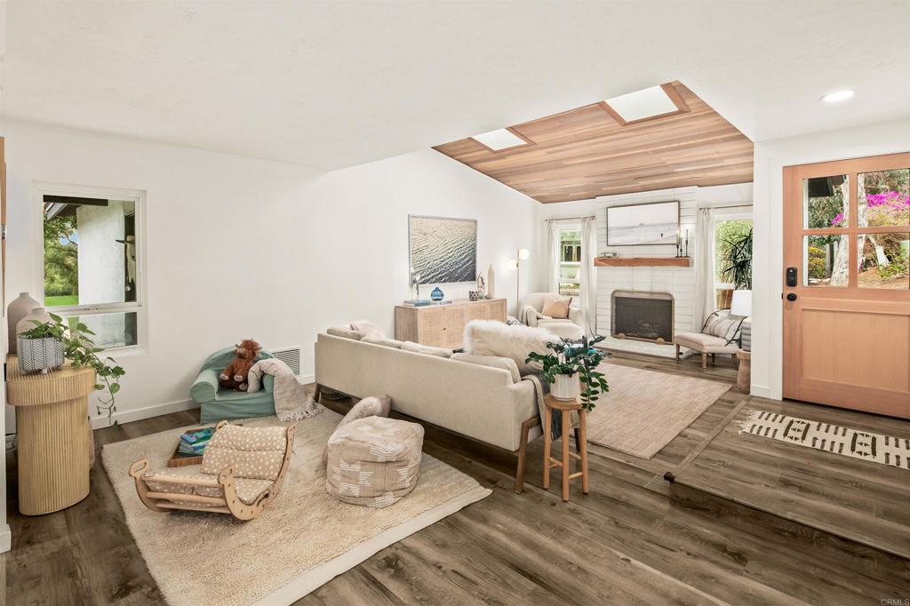 1427 Avocado Road Oceanside, CA 92054 - Photo 7 of 60 a living room with furniture and a fireplace