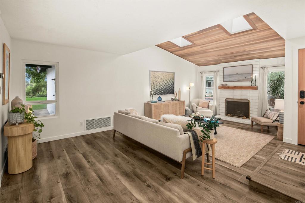 1427 Avocado Road Oceanside, CA 92054 - Photo 8 of 60 a living room with furniture wooden floor and a fireplace