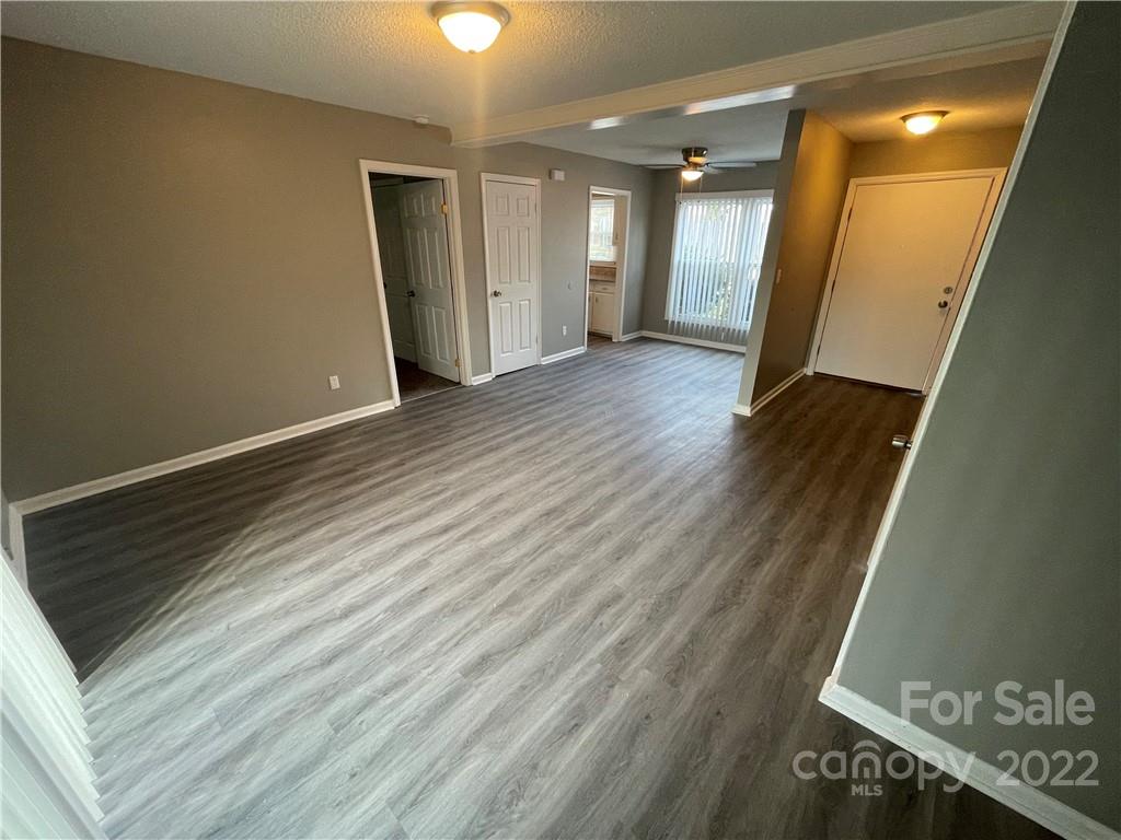 270 Spring Street Southwest Concord, NC 28025 - Photo 4 of 8 a view of a hallway with wooden floor