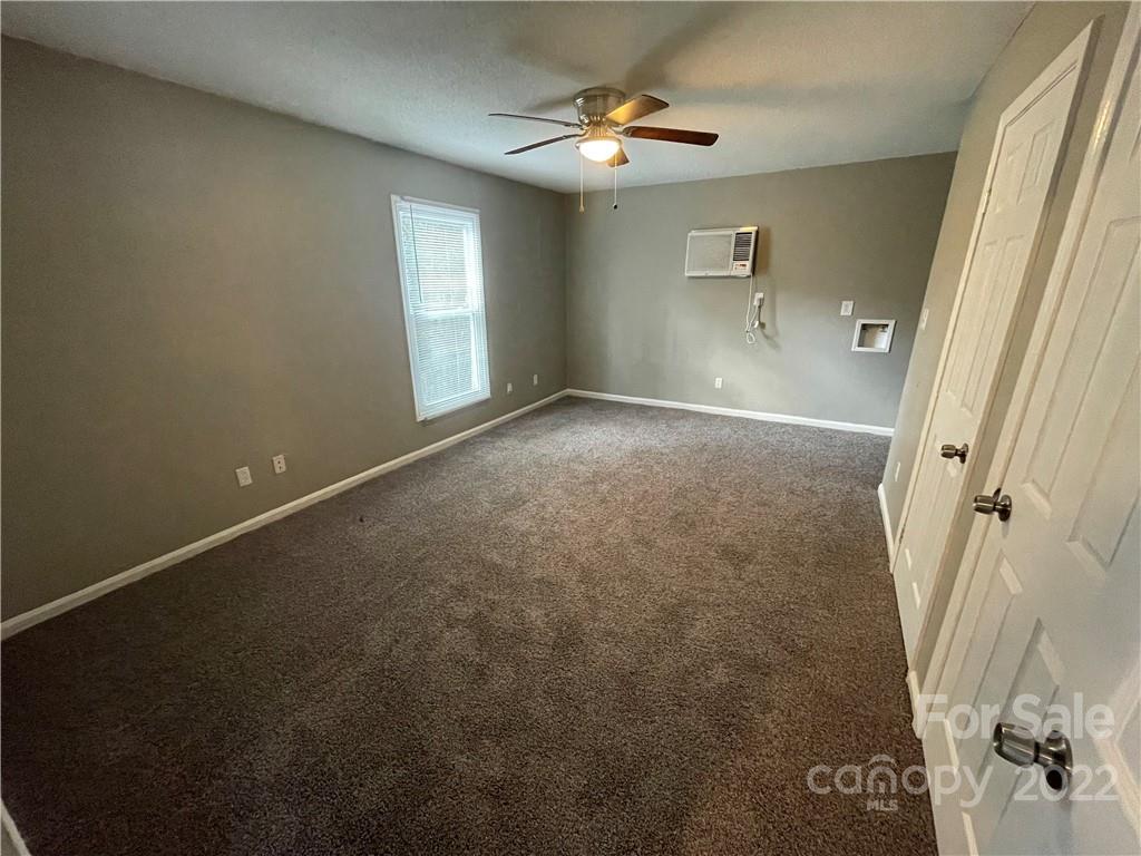 270 Spring Street Southwest Concord, NC 28025 - Photo 5 of 8 en empty room with windows and fan
