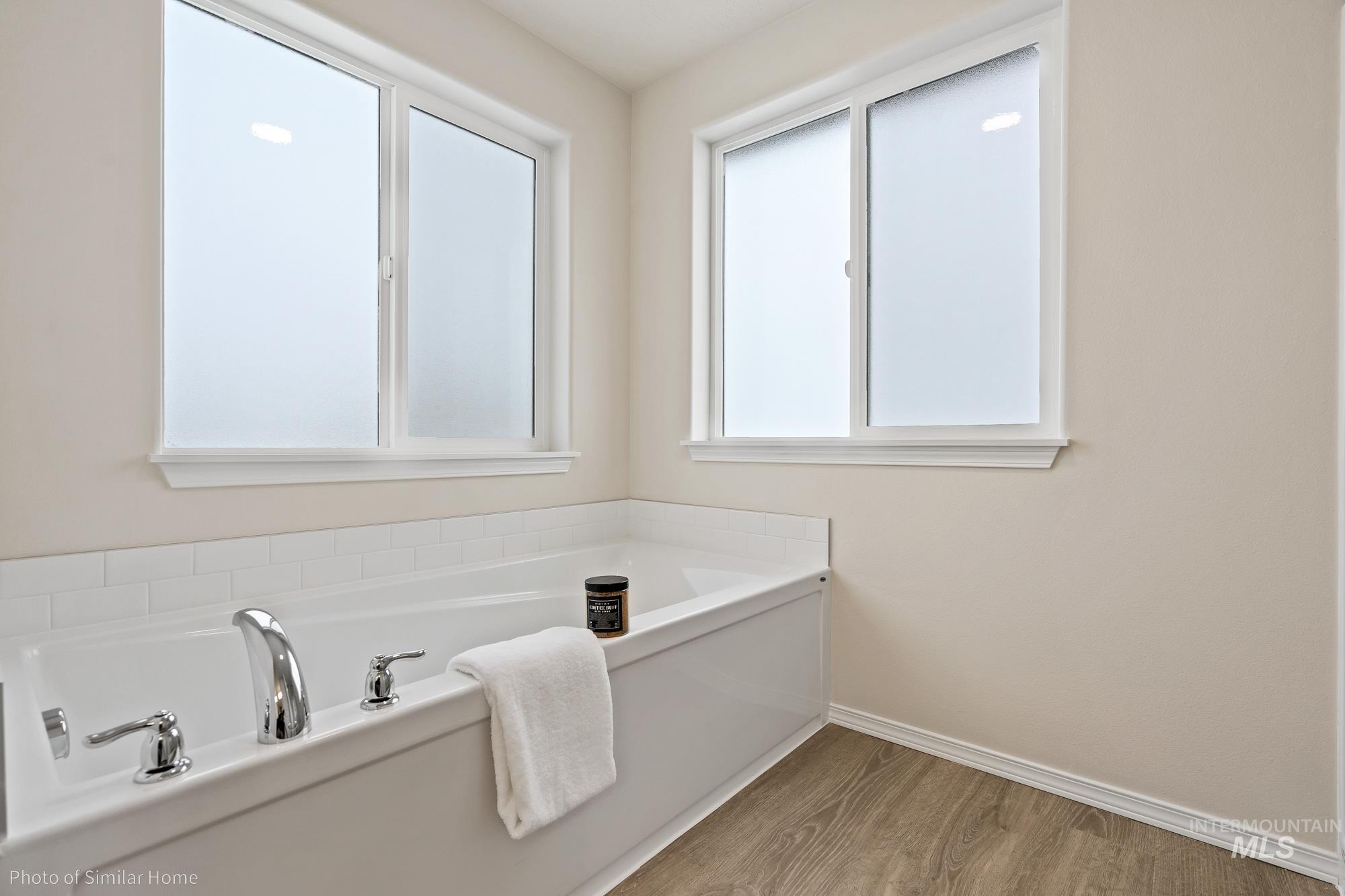 877 West Roan Ridge Nampa, ID 83686 - Photo 11 of 13 Full bath with a garden tub and light wood-style flooring