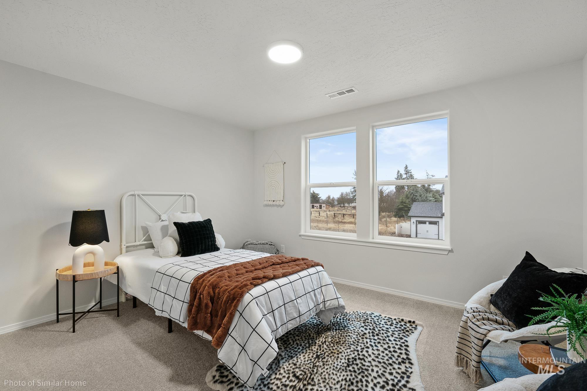 877 West Roan Ridge Nampa, ID 83686 - Photo 2 of 13 Bedroom featuring light carpet and a textured ceiling
