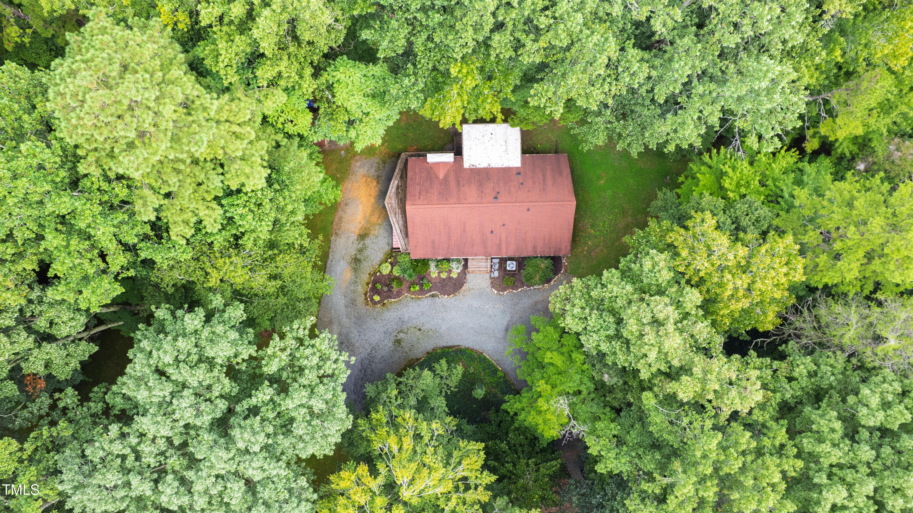 5415 Bradshaw Quarry Road Efland, NC 27243 - Photo 10 of 65 an aerial view of a house with a yard and large trees