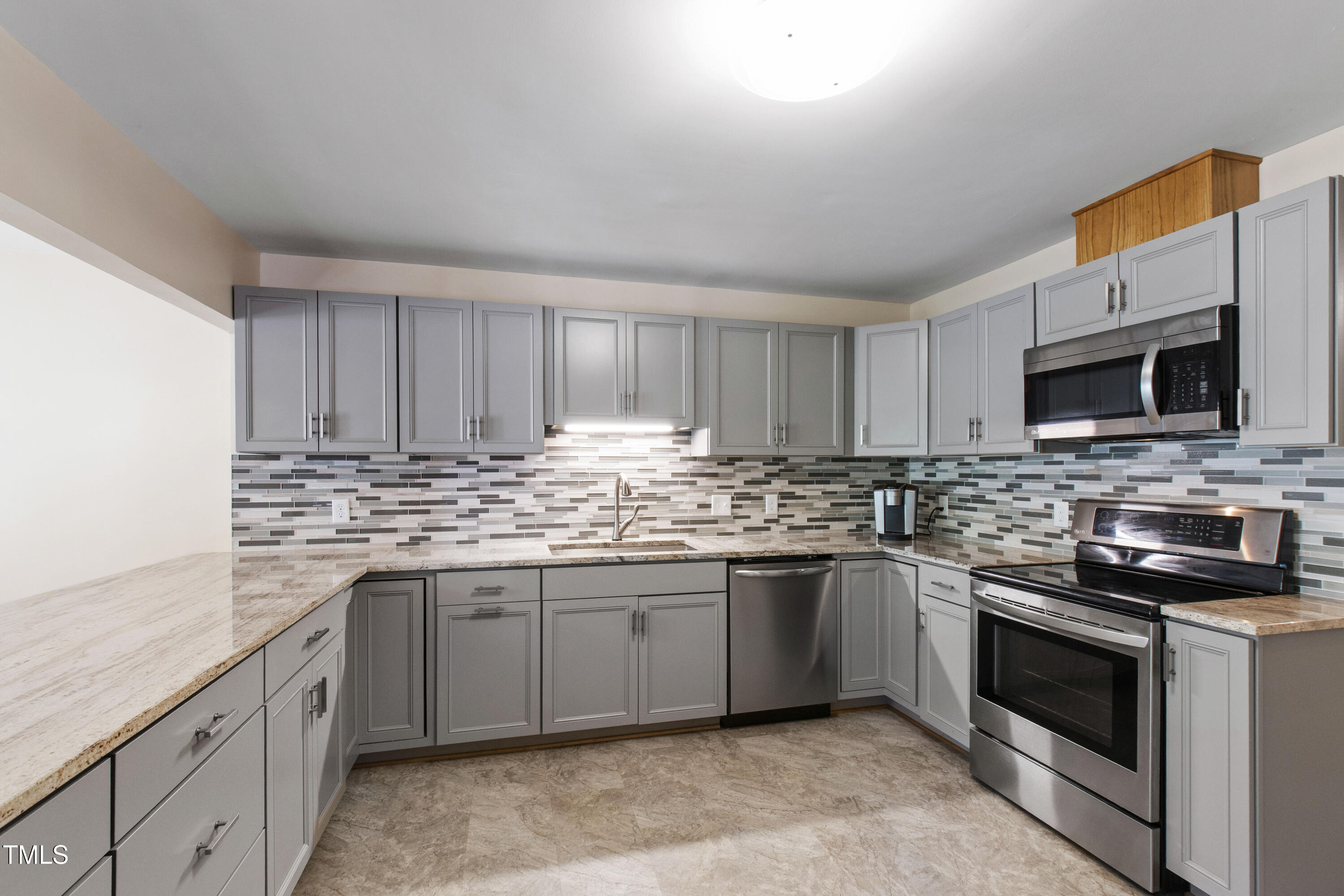 5415 Bradshaw Quarry Road Efland, NC 27243 - Photo 11 of 65 a kitchen with stainless steel appliances granite countertop a stove top oven a sink dishwasher and a microwave oven with cabinets