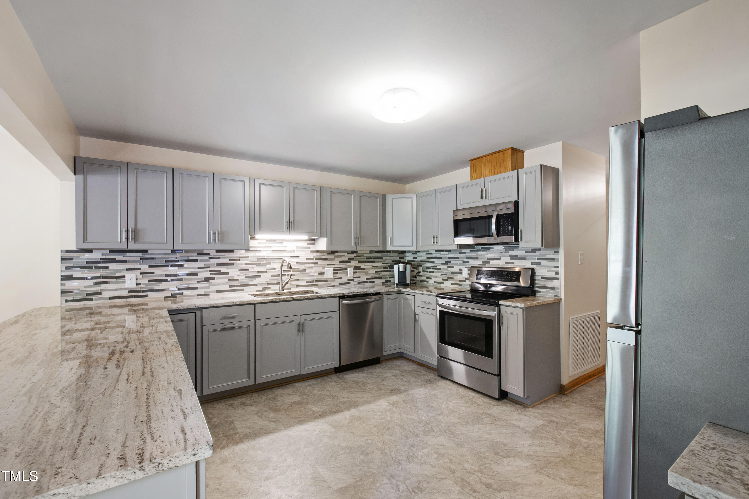 5415 Bradshaw Quarry Road Efland, NC 27243 - Photo 12 of 65 a kitchen with stainless steel appliances granite countertop a stove sink and refrigerator