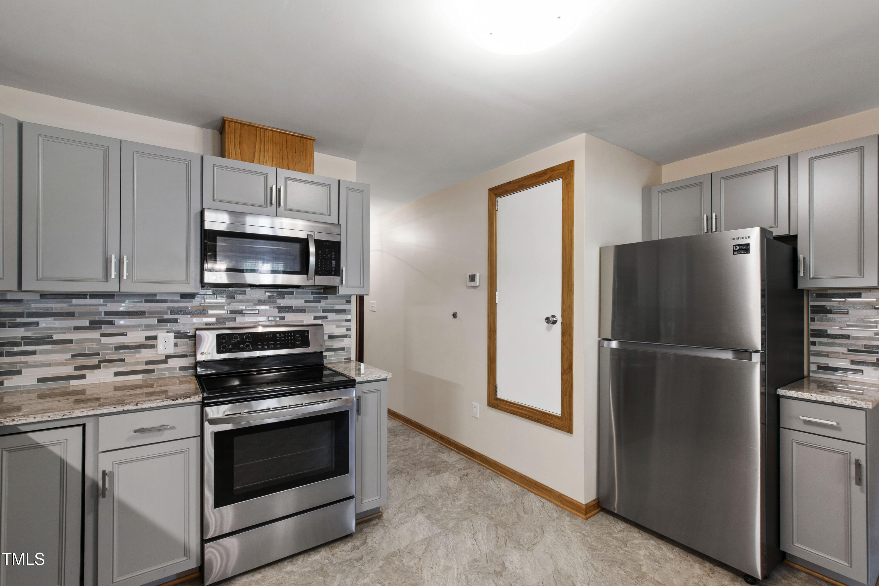 5415 Bradshaw Quarry Road Efland, NC 27243 - Photo 14 of 65 a kitchen with stainless steel appliances a refrigerator stove and microwave