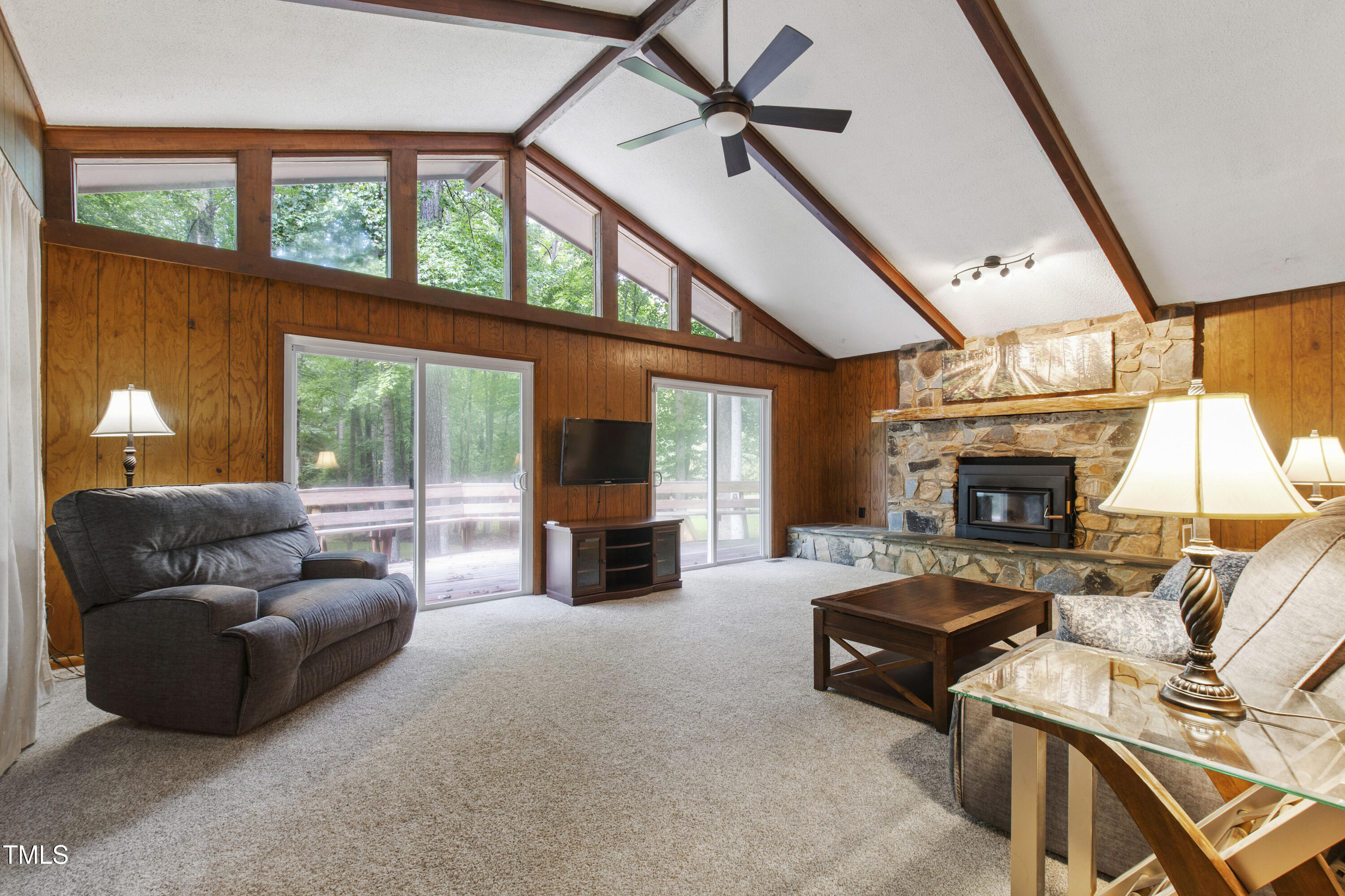 5415 Bradshaw Quarry Road Efland, NC 27243 - Photo 18 of 65 a living room with furniture a fireplace and a floor to ceiling window