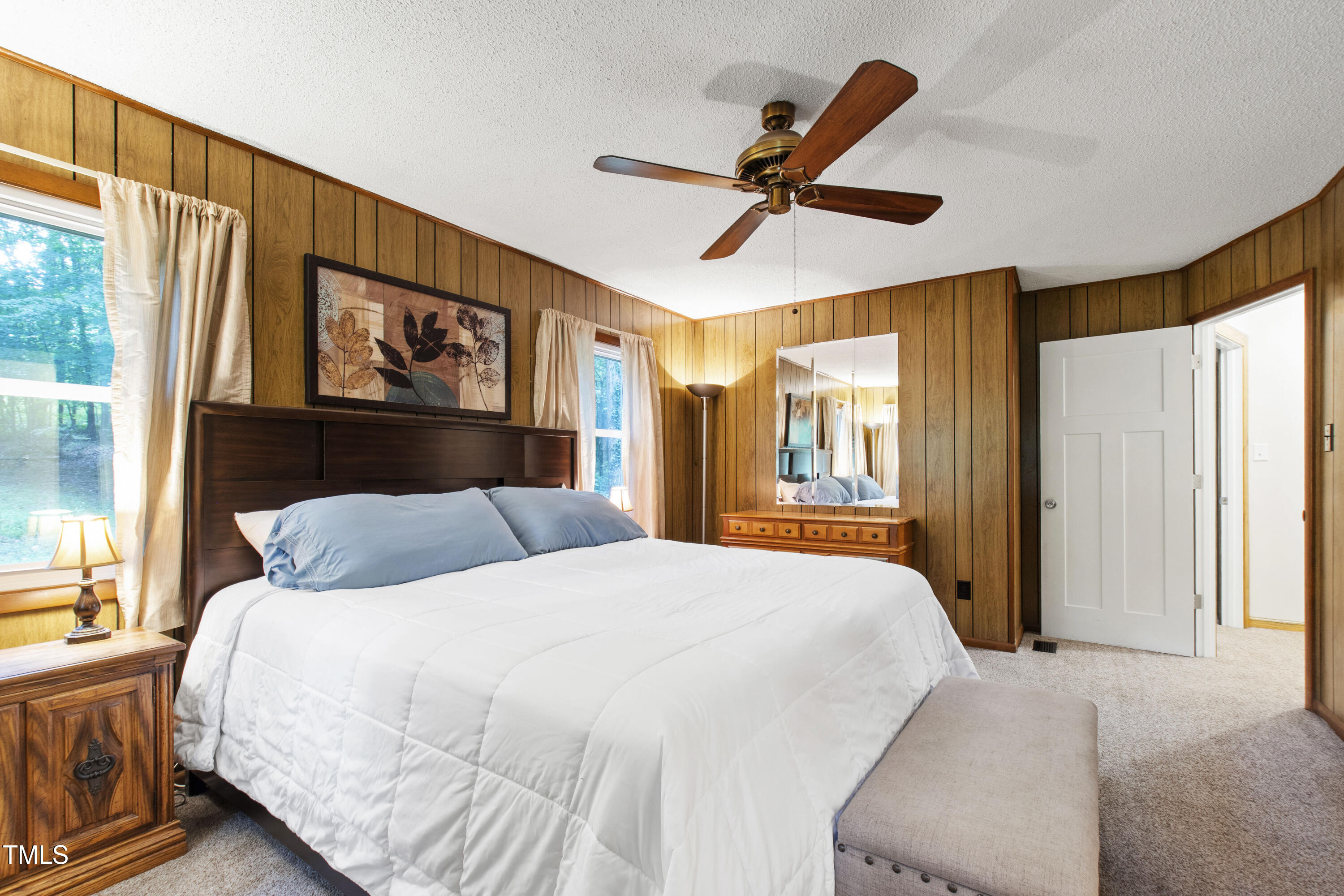 5415 Bradshaw Quarry Road Efland, NC 27243 - Photo 28 of 65 a bedroom with a large bed and a large window