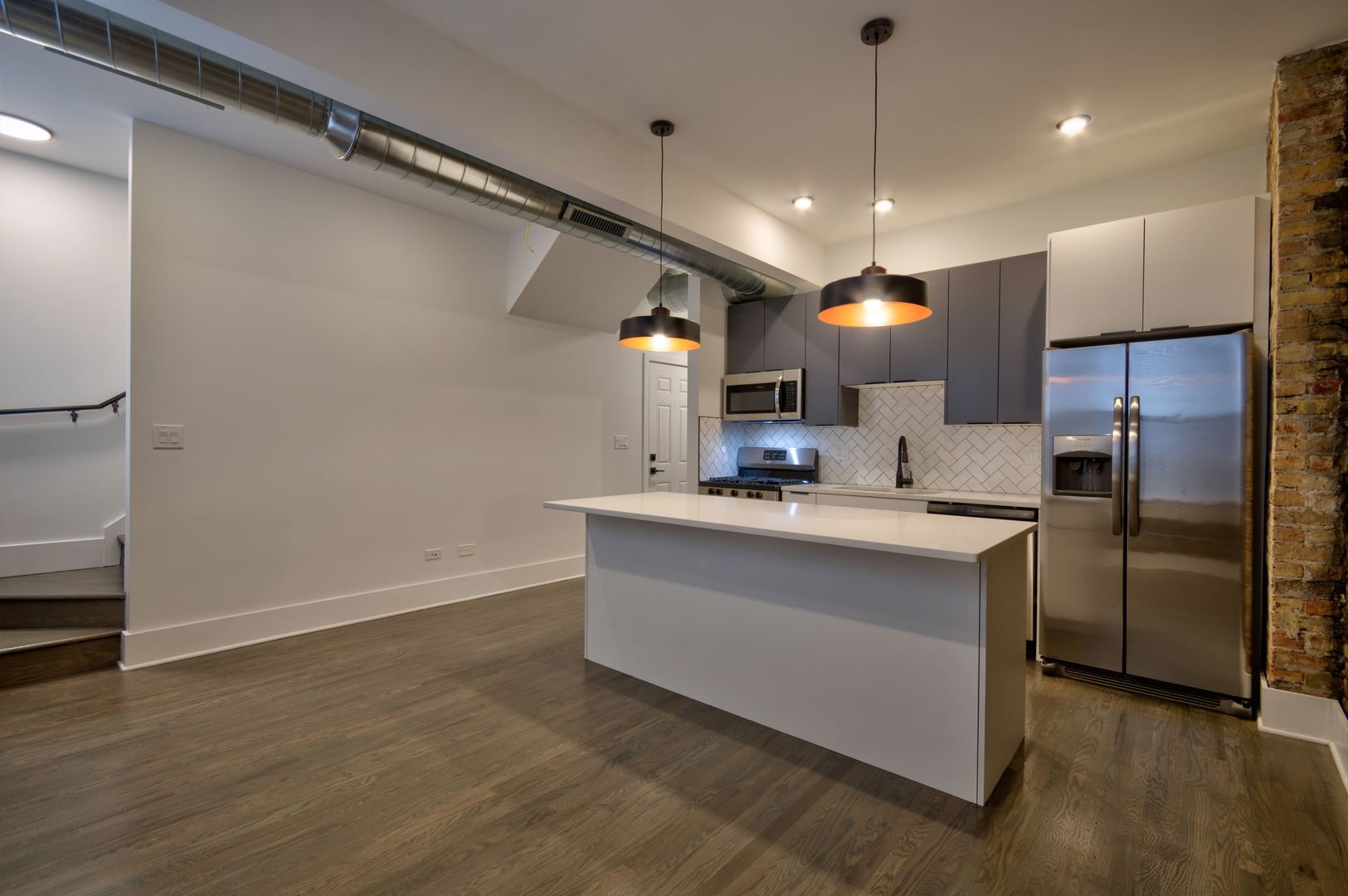 1917 South Racine Avenue, Unit 2F Chicago, IL 60608 - Photo 3 of 13 a kitchen with stainless steel appliances kitchen island a refrigerator sink and stove