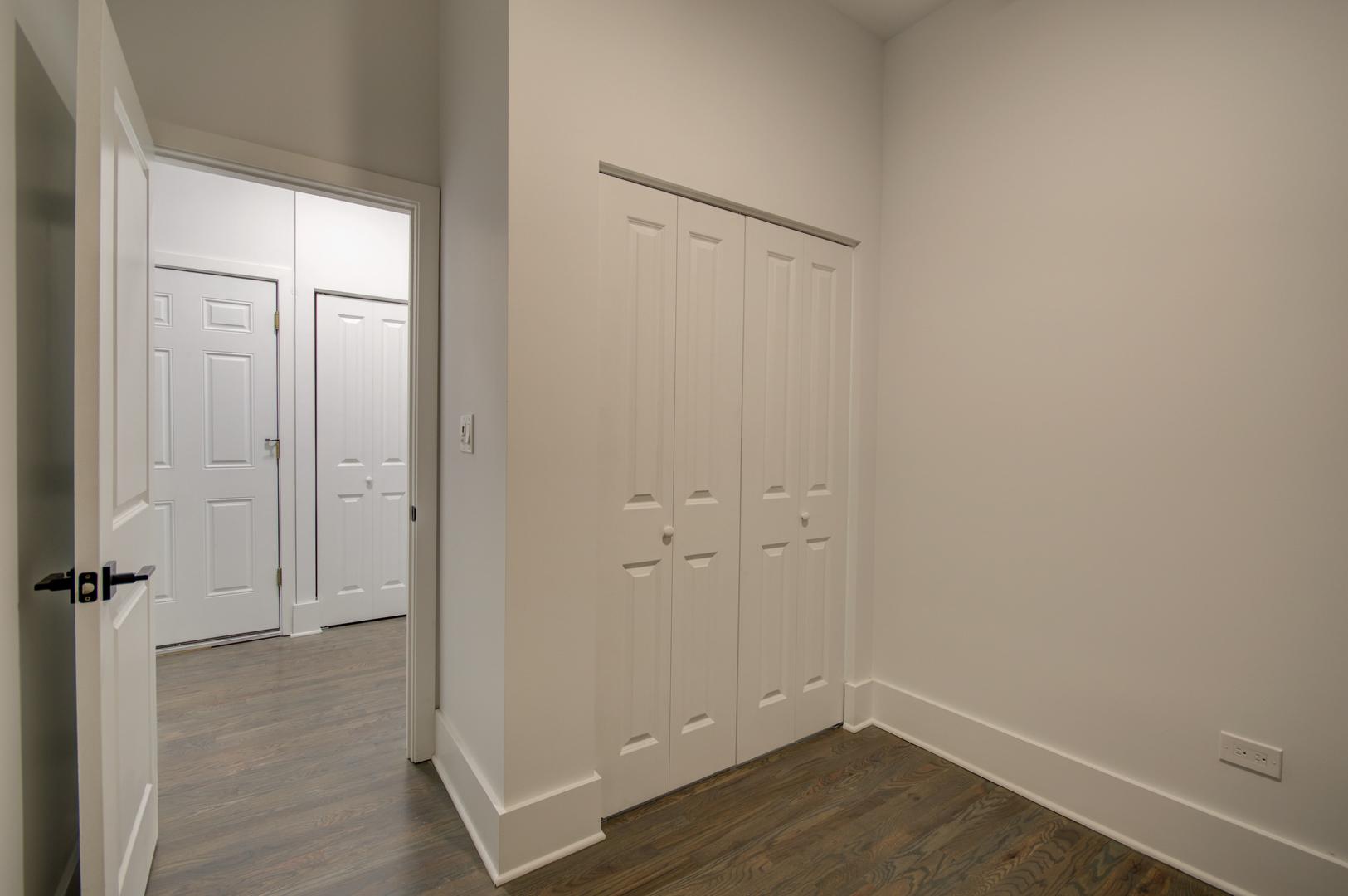 1917 South Racine Avenue, Unit 2F Chicago, IL 60608 - Photo 6 of 13 an empty room with wooden floor