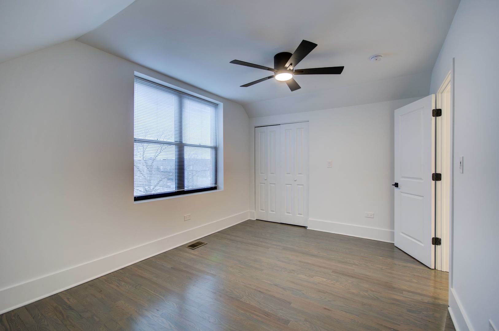 1917 South Racine Avenue, Unit 2F Chicago, IL 60608 - Photo 8 of 13 a view of an empty room with wooden floor and a window