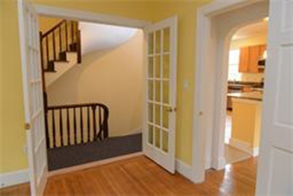 71 Fordham Road, Unit 71 Newton, MA 02465 - Photo 7 of 15 a view of a hallway with wooden floor and staircase