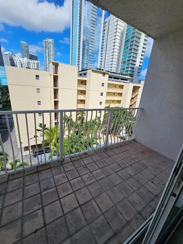 a view of a chairs and table in the balcony