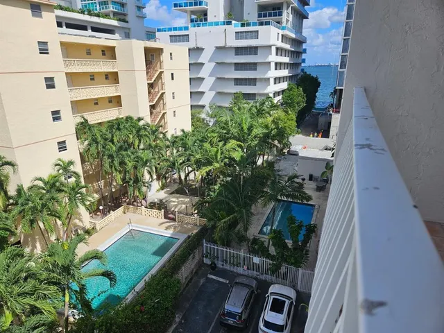 a view of building with yard and staircase