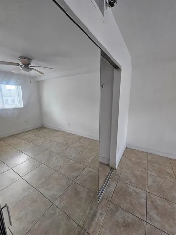 a kitchen with a refrigerator a stove top oven a sink a counter top space and cabinets