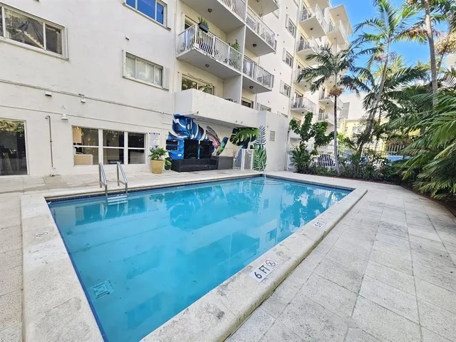 a view of a swimming pool with an outdoor seating