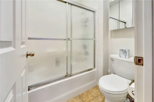 a spacious bedroom with a bed and a chandelier