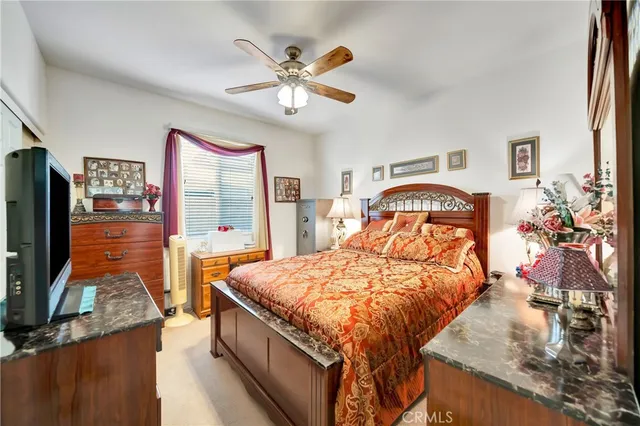 a bedroom with a large bed and a chandelier
