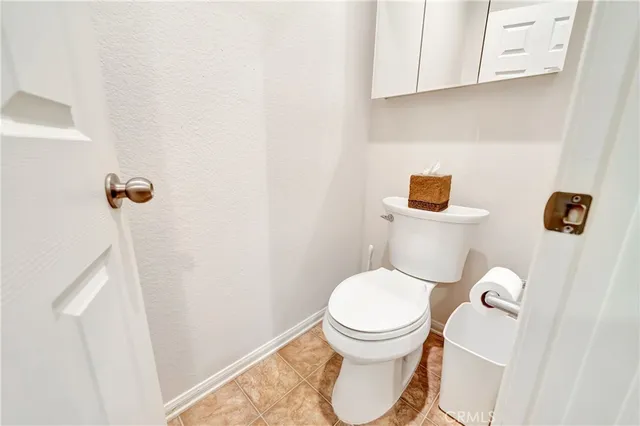 a view of a patio with table and chairs and a large tree