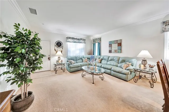a dining room with furniture and a chandelier