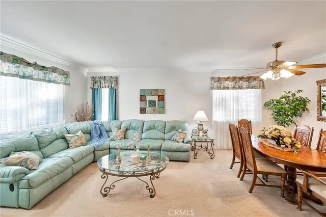 a view of a dining room with furniture a chandelier and wooden floor