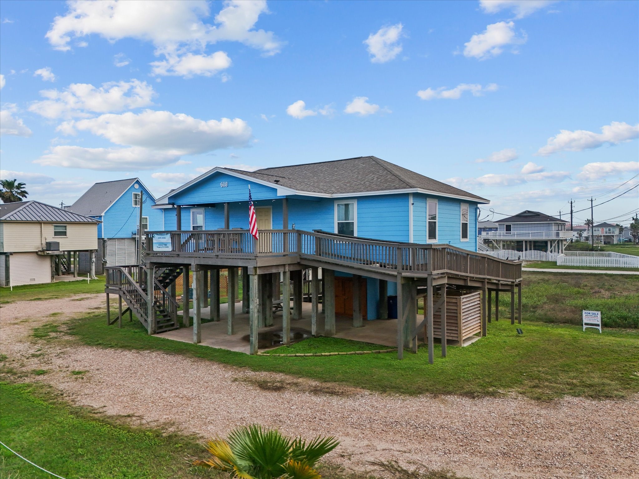 818 Surf Drive Surfside Beach, TX 77541 - Photo 4 of 29 This beach house features a spacious wraparound deck, ample parking underneath, and a charming coastal vibe, perfect for enjoying seaside living.