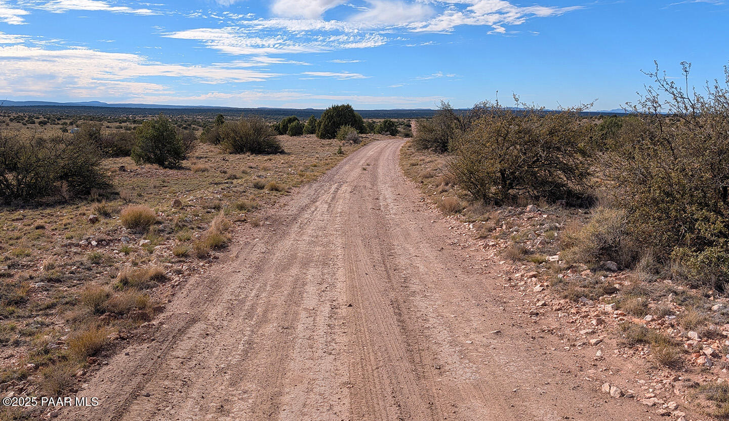 0 West Via Dolorosa Road Seligman, AZ 86337 - Photo 21 of 39 a view of a dry yard with wooden fence