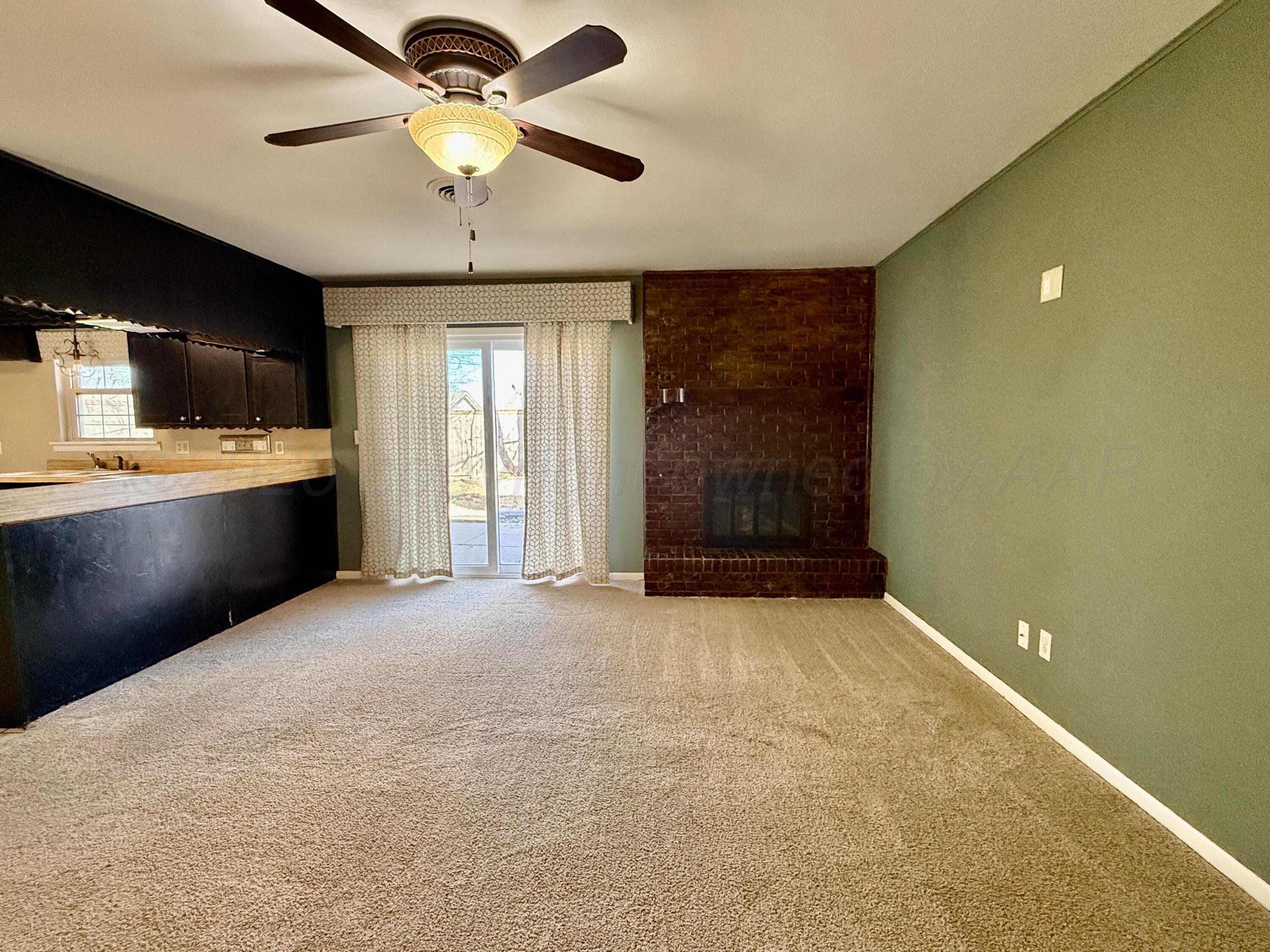 1509 Pellinore Street Borger, TX 79007 - Photo 13 of 22 a view of an empty room with a kitchen