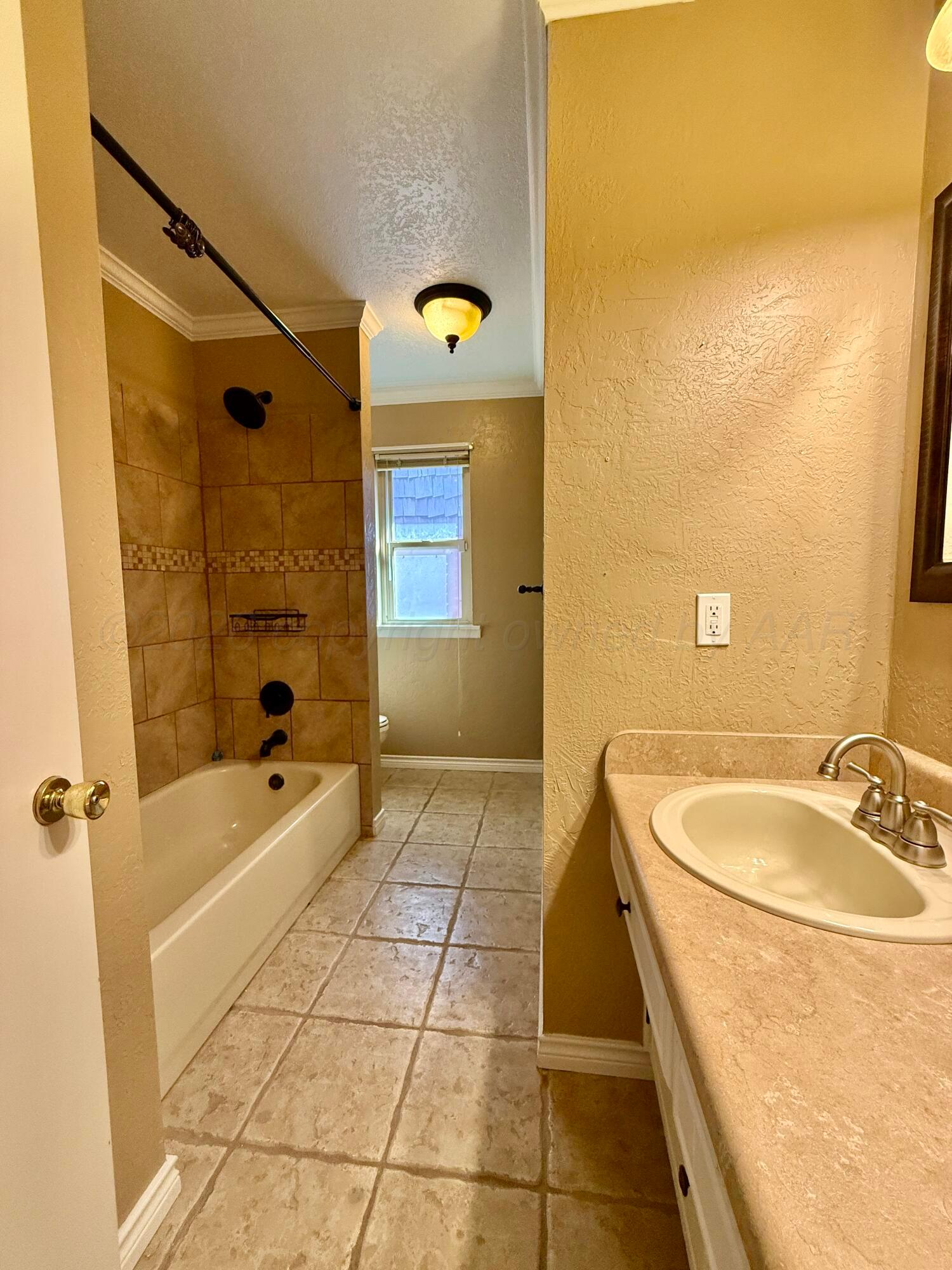 1509 Pellinore Street Borger, TX 79007 - Photo 16 of 22 a bathroom with a sink a toilet and shower