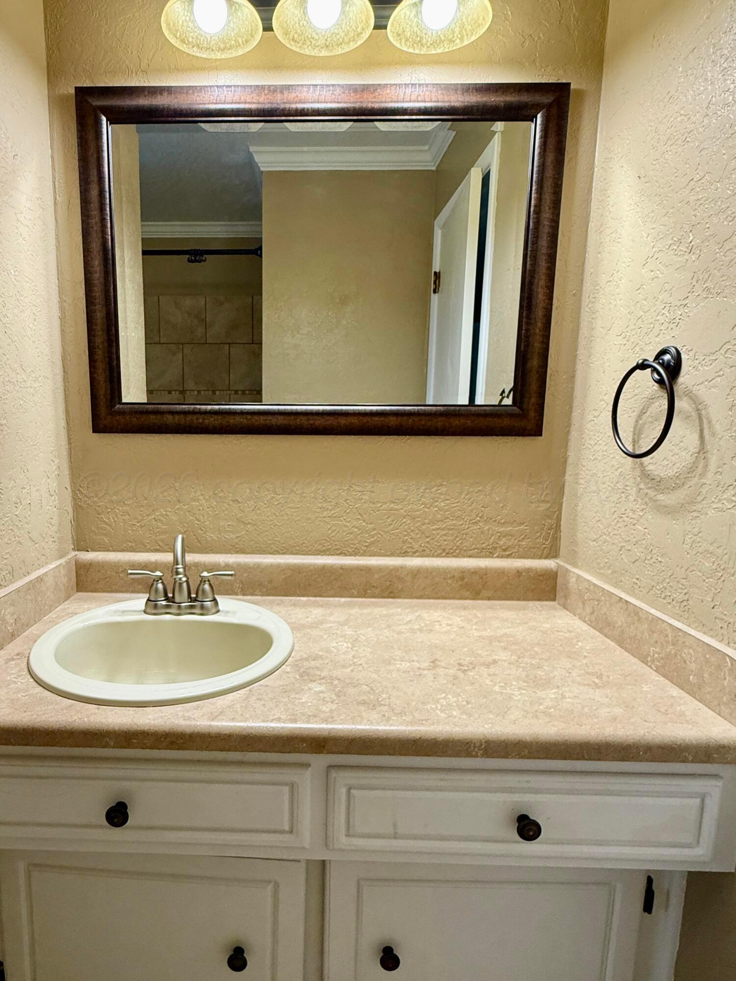 1509 Pellinore Street Borger, TX 79007 - Photo 18 of 22 a bathroom with a sink and a mirror