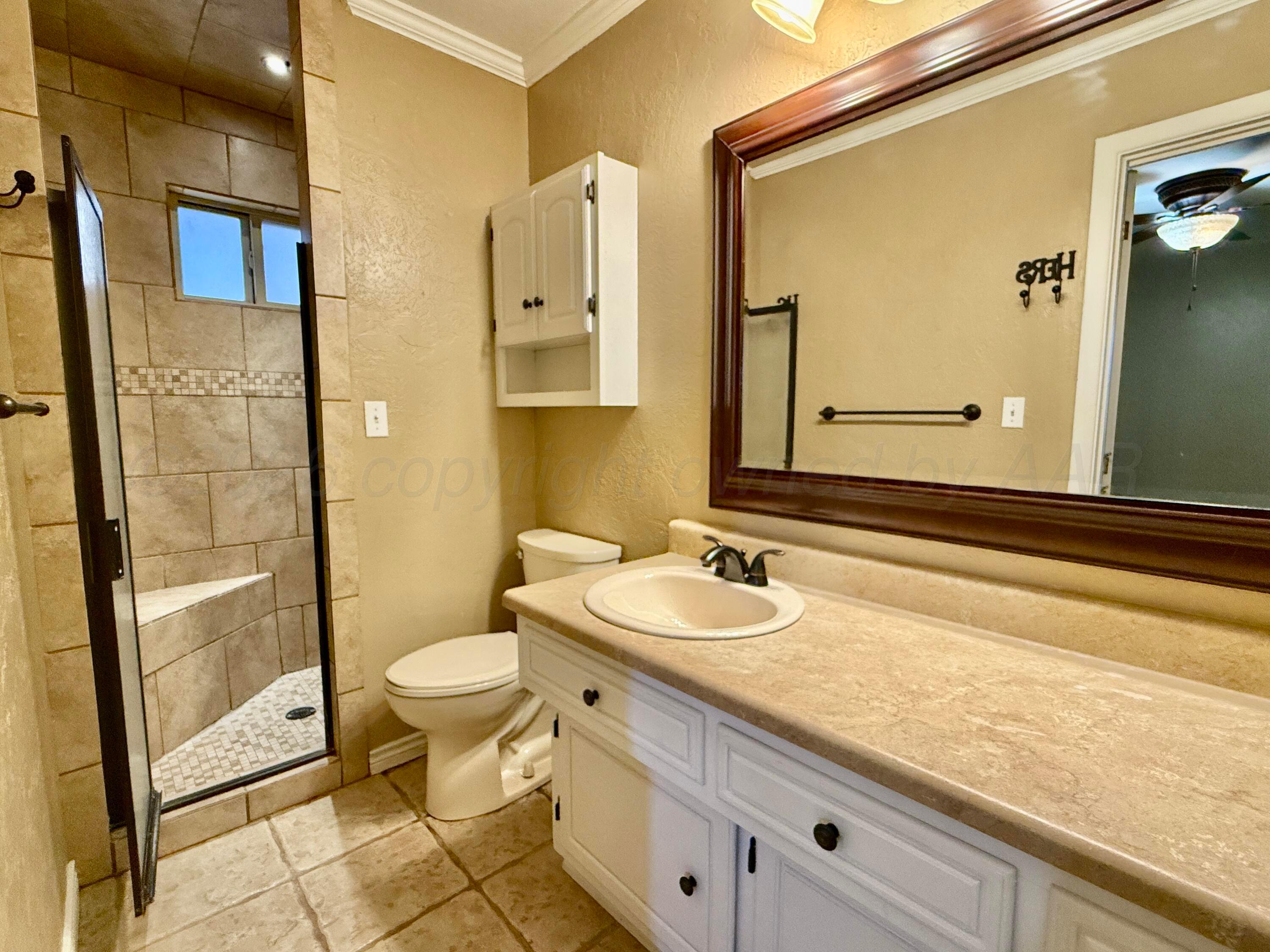 1509 Pellinore Street Borger, TX 79007 - Photo 19 of 22 a bathroom with a granite countertop sink toilet and shower