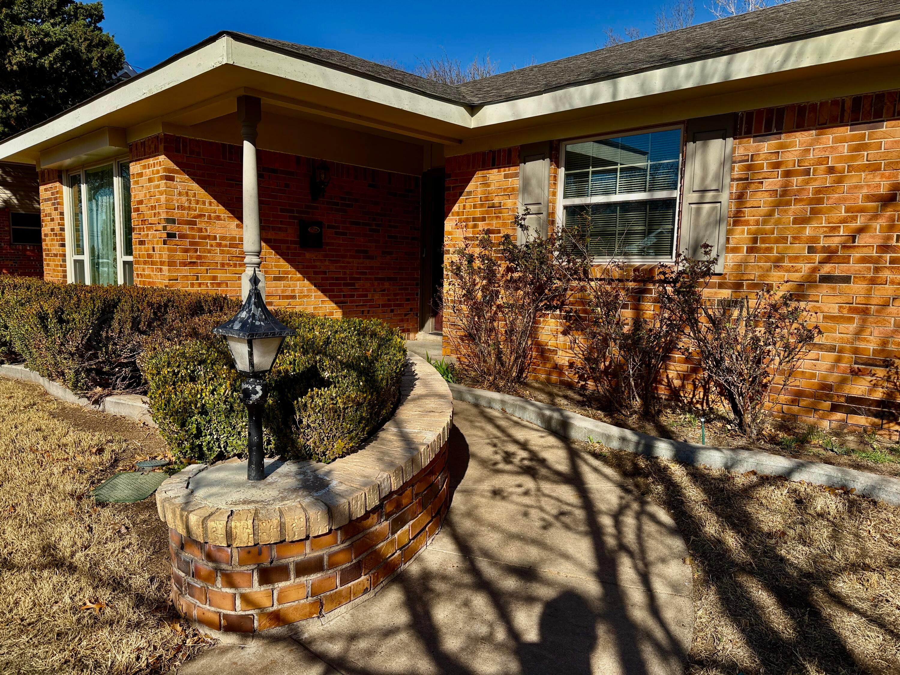 1509 Pellinore Street Borger, TX 79007 - Photo 3 of 22 a front view of a house with garden