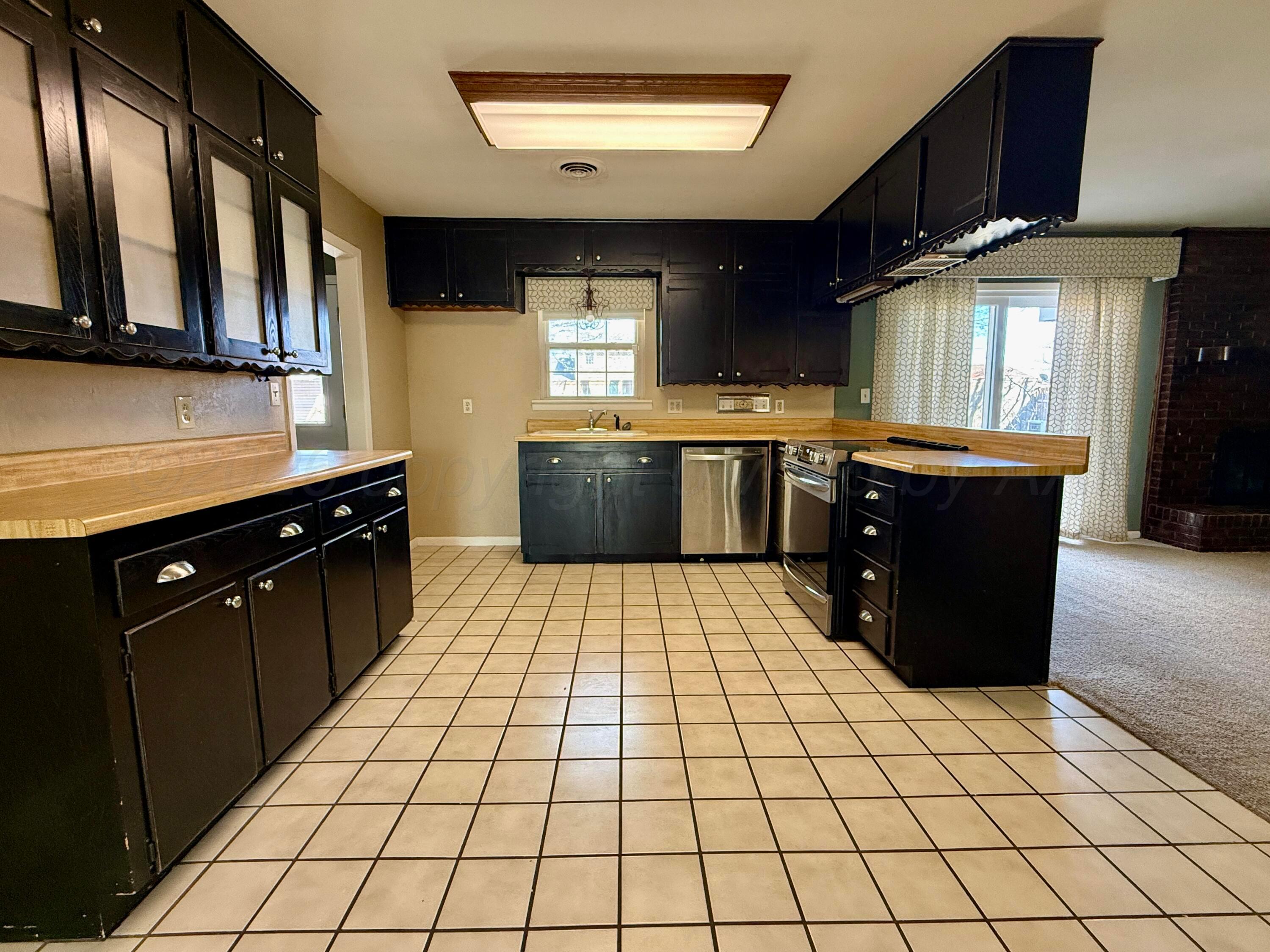 1509 Pellinore Street Borger, TX 79007 - Photo 8 of 22 a kitchen with stainless steel appliances granite countertop a sink and cabinets