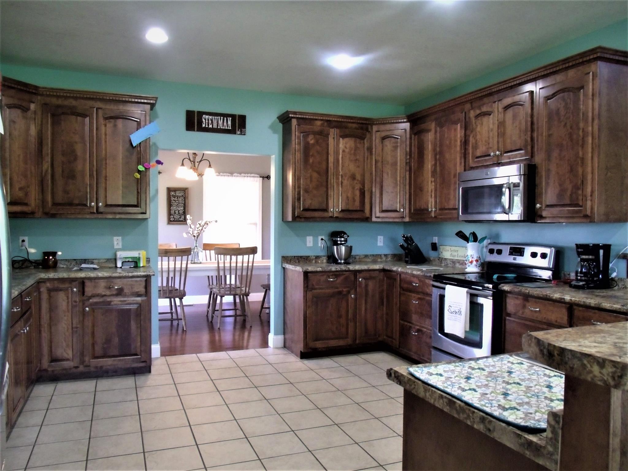 3550 Williams Cove Road Winchester, TN 37398 - Photo 7 of 26 a kitchen with stainless steel appliances granite countertop a stove top oven a sink dishwasher and a refrigerator with wooden cabinets