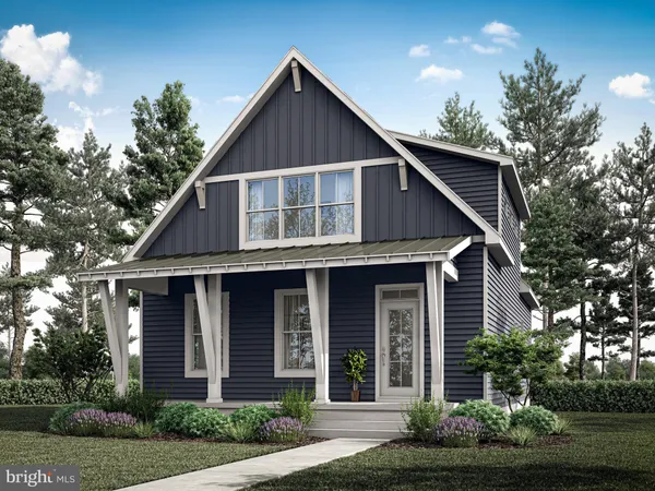 a front view of a house with a yard and potted plants